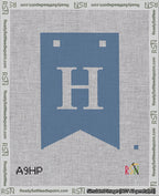 A taped needlepoint canvas with the design: Banner 18 mesh count Forked H White on Blue.