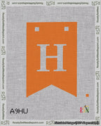 A taped needlepoint canvas with the design: Banner 18 mesh count Forked H White on Orange.