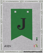 A taped needlepoint canvas with the design: Banner 18 mesh count Forked J Black on Green.