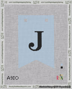 A taped needlepoint canvas with the design: Banner 18 mesh count Forked J Black on Light Blue.
