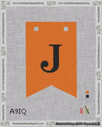 A taped needlepoint canvas with the design: Banner 18 mesh count Forked J Black on Orange.