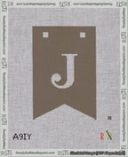 A taped needlepoint canvas with the design: Banner 18 mesh count Forked J White on Brown.