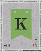 A taped needlepoint canvas with the design: Banner 18 mesh count Forked K Black on Light Green.