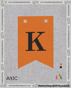 A taped needlepoint canvas with the design: Banner 18 mesh count Forked K Black on Orange.
