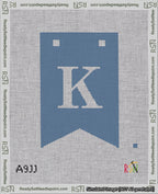 A taped needlepoint canvas with the design: Banner 18 mesh count Forked K White on Blue.