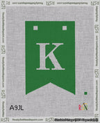 A taped needlepoint canvas with the design: Banner 18 mesh count Forked K White on Green.
