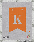 A taped needlepoint canvas with the design: Banner 18 mesh count Forked K White on Orange.