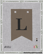 A taped needlepoint canvas with the design: Banner 18 mesh count Forked L Black on Brown.