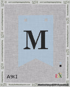 A taped needlepoint canvas with the design: Banner 18 mesh count Forked M Black on Light Blue.