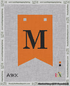 A taped needlepoint canvas with the design: Banner 18 mesh count Forked M Black on Orange.