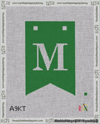 A taped needlepoint canvas with the design: Banner 18 mesh count Forked M White on Green.
