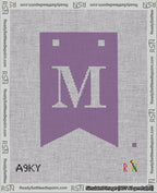 A taped needlepoint canvas with the design: Banner 18 mesh count Forked M White on Purple.