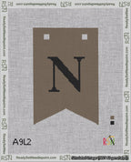 A taped needlepoint canvas with the design: Banner 18 mesh count Forked N Black on Brown.
