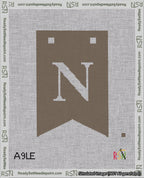 A taped needlepoint canvas with the design: Banner 18 mesh count Forked N White on Brown.