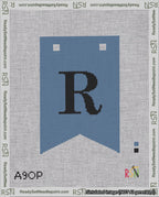 A taped needlepoint canvas with the design: Banner 18 mesh count Forked R Black on Blue.
