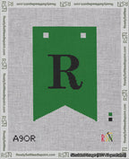 A taped needlepoint canvas with the design: Banner 18 mesh count Forked R Black on Green.