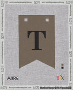 A taped needlepoint canvas with the design: Banner 18 mesh count Forked T Black on Brown.