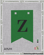 A taped needlepoint canvas with the design: Banner 18 mesh count Forked Z Black on Green.