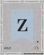 A taped needlepoint canvas with the design: Banner 18 mesh count Forked Z Black on Light Blue.