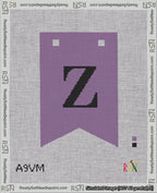 A taped needlepoint canvas with the design: Banner 18 mesh count Forked Z Black on Purple.