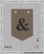 A taped needlepoint canvas with the design: Banner 18 mesh count Pointed Ampersand Black on Brown.