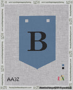 A taped needlepoint canvas with the design: Banner 18 mesh count Pointed B Black on Blue.