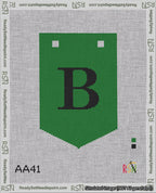 A taped needlepoint canvas with the design: Banner 18 mesh count Pointed B Black on Green.