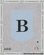 A taped needlepoint canvas with the design: Banner 18 mesh count Pointed B Black on Light Blue.