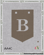 A taped needlepoint canvas with the design: Banner 18 mesh count Pointed B White on Brown.