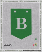 A taped needlepoint canvas with the design: Banner 18 mesh count Pointed B White on Green.