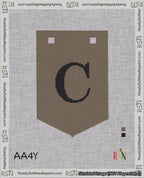 A taped needlepoint canvas with the design: Banner 18 mesh count Pointed C Black on Brown.