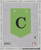 A taped needlepoint canvas with the design: Banner 18 mesh count Pointed C Black on Light Green.