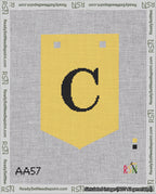 A taped needlepoint canvas with the design: Banner 18 mesh count Pointed C Black on Yellow.