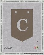 A taped needlepoint canvas with the design: Banner 18 mesh count Pointed C White on Brown.