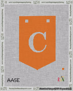 A taped needlepoint canvas with the design: Banner 18 mesh count Pointed C White on Orange.