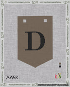 A taped needlepoint canvas with the design: Banner 18 mesh count Pointed D Black on Brown.