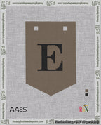 A taped needlepoint canvas with the design: Banner 18 mesh count Pointed E Black on Brown.