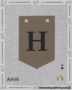 A taped needlepoint canvas with the design: Banner 18 mesh count Pointed H Black on Brown.
