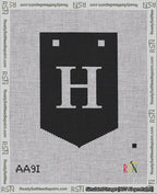 A taped needlepoint canvas with the design: Banner 18 mesh count Pointed H White on Black.