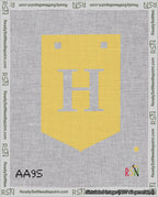 A taped needlepoint canvas with the design: Banner 18 mesh count Pointed H White on Yellow.