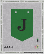 A taped needlepoint canvas with the design: Banner 18 mesh count Pointed J Black on Green.