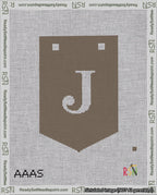 A taped needlepoint canvas with the design: Banner 18 mesh count Pointed J White on Brown.
