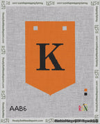 A taped needlepoint canvas with the design: Banner 18 mesh count Pointed K Black on Orange.