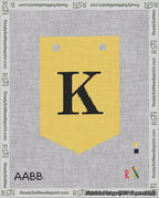 A taped needlepoint canvas with the design: Banner 18 mesh count Pointed K Black on Yellow.
