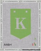 A taped needlepoint canvas with the design: Banner 18 mesh count Pointed K White on Light Green.
