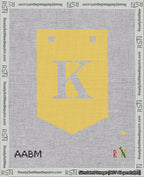 A taped needlepoint canvas with the design: Banner 18 mesh count Pointed K White on Yellow.