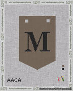 A taped needlepoint canvas with the design: Banner 18 mesh count Pointed M Black on Brown.