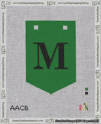 A taped needlepoint canvas with the design: Banner 18 mesh count Pointed M Black on Green.