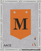 A taped needlepoint canvas with the design: Banner 18 mesh count Pointed M Black on Orange.