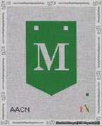 A taped needlepoint canvas with the design: Banner 18 mesh count Pointed M White on Green.